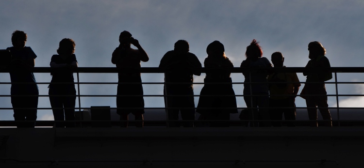 line of passengers on ship saying goodbye